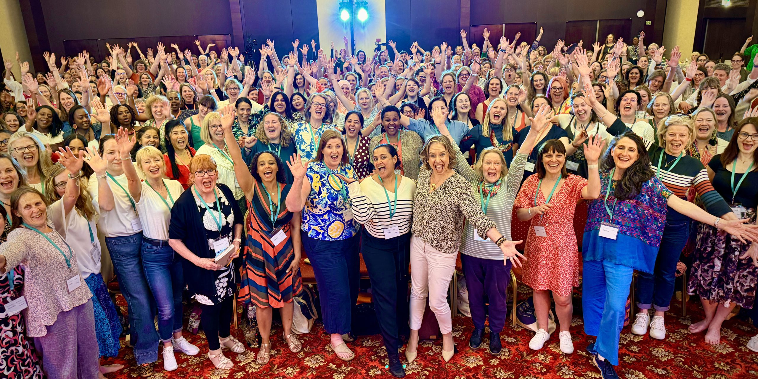 Jo and the One of Many community celebrating at the One Woman Conference 2025.